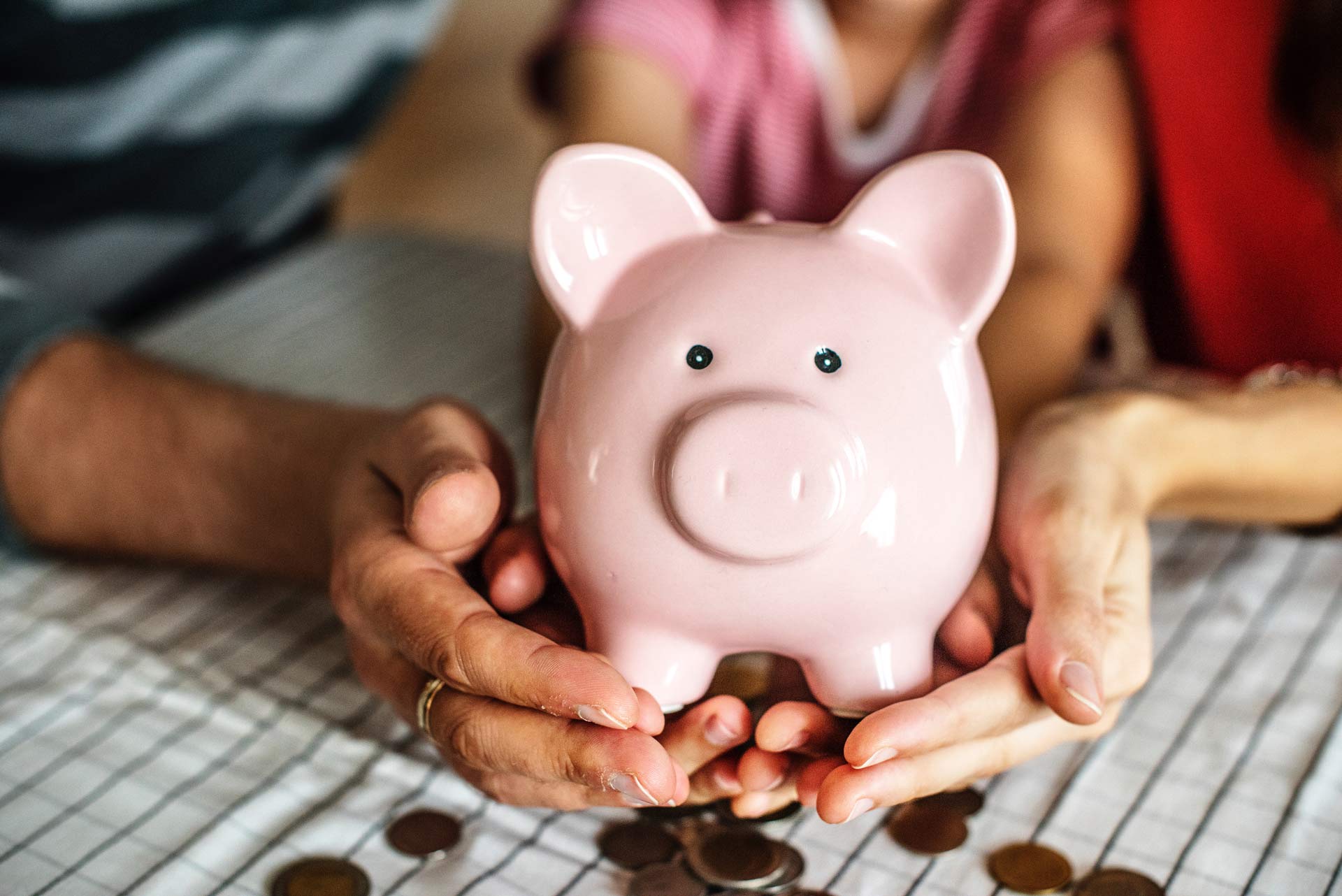 family holding a piggy bank