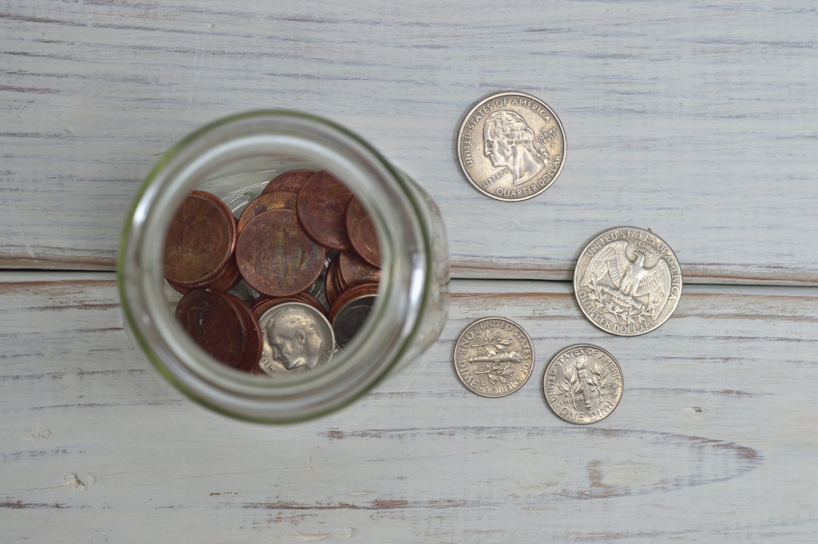 USD coins in a glass jar