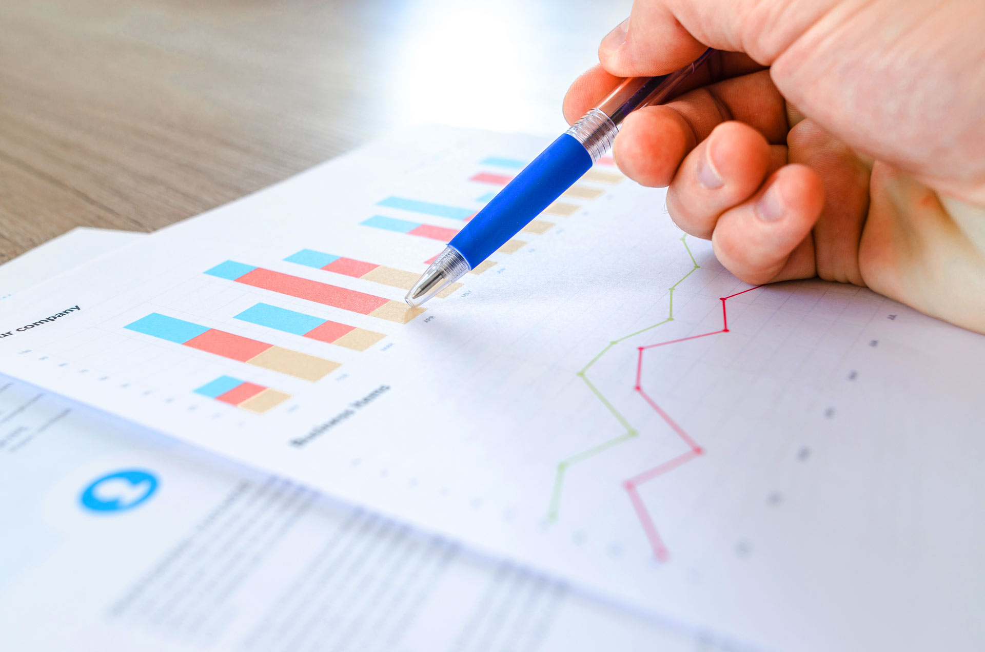 pen pointing at graph on a piece of paper