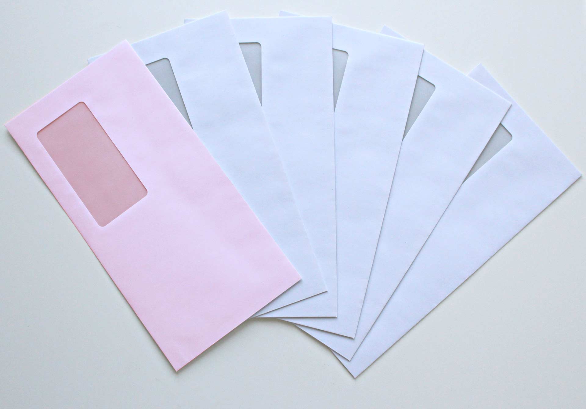 5 white envelopes and 1 pink envelope